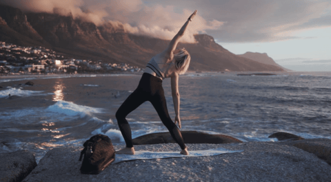 woman with healthy bones and joints doing yoga by ocean from benefits of growth max