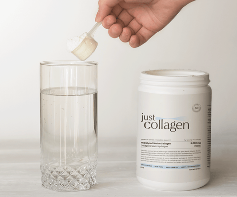 adding scoop of hydrolyzed marine collagen powder to glass of water